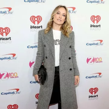 Saint Laurent Double Breasted Herringbone Wool Coat worn by Olivia Wilde iHeartRadio Jingle Ball December 13, 2019