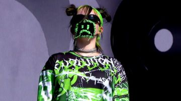 Sad emoji mask worn by Billie Eilish at Reading Festival 2019