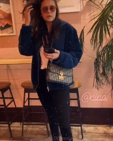 Dior Lat­te Mul­ti­col­or Ful­ly Em­broi­dered Strap worn by Nina Dobrev Farmer’s Market, December 15, 2019