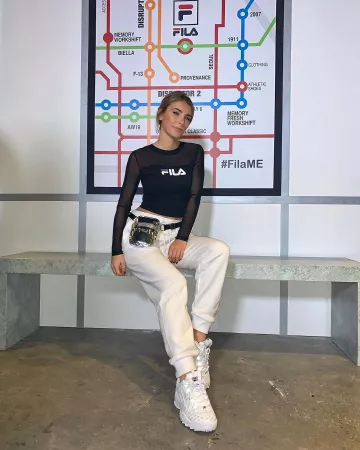 The white sneakers with the Fila logo, Eva Colas on the account Instagram of @evacolasoff