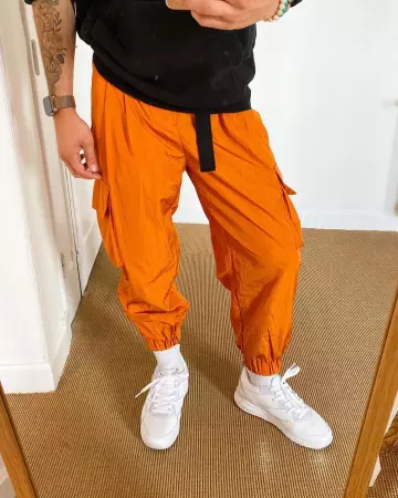 Pants joggers nylon orange thomas suissa on the account Instagram of @asos_thomas