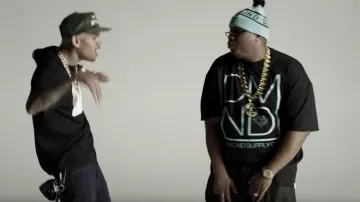 Blue hat ponpon line of text of E-40 in Music Video: E-40 "Function (Coast to Coast Remix)"