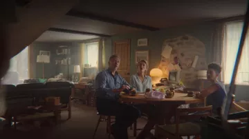 The shirt is sky-blue fluid of John Milburn (Gillian Anderson) in Sex Education (Season 2 Episode 1)