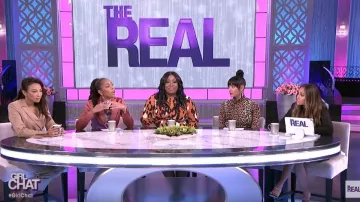 Ganni Leop­ard Print Mesh Turtle­neck worn by Tamera Mowry on The Real January 20, 2020