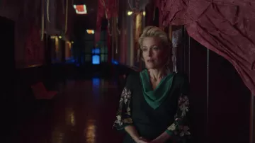 The black dress sleeved flowers worn by John Milburn (Gillian Anderson) in the series Sex Education (Season 2 Episode 8)