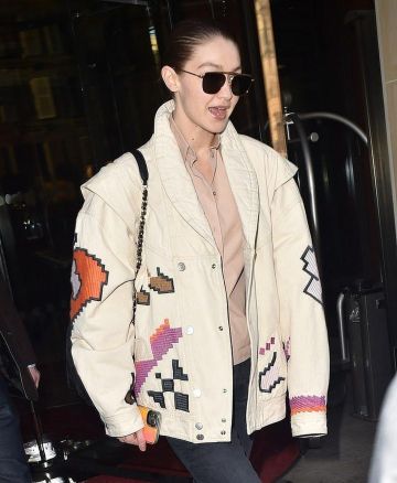 Chanel Back­pack Quilt­ed Gold CC Bag Purse worn by Jelena Noura "Gigi" Hadid Hotel Le Royal Monceau Raffles Paris January 22, 2020