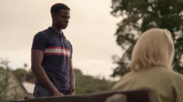 The polo blue with red stripes Jackson Marchetti (Kedar Williams-Stirling) in Sex Education (Season 2 Episode 7)