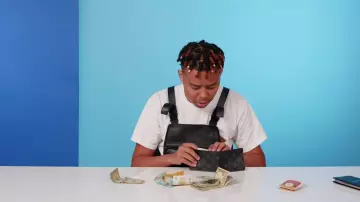 Louis Vuitton Monogram Eclipse Canvas Slender Wallets worn by YBN Cordae in 10 Things YBN Cordae Can't Live Without | GQ