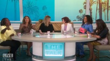 Ganni Blue Flo­ral Print Silk Shirt worn by Eve on The Talk February 12, 2020