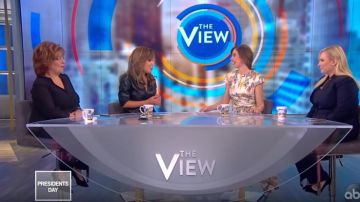 Nanushka Pene­lope V-neck Wrap Faux Leather Dress worn by Sunny Hostin on The View February 17, 2020