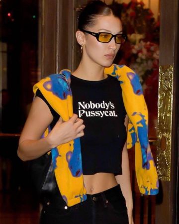 24 hr laundry No­body's Pussy­cat tee worn by  Bella Hadid Paris February 24, 2020