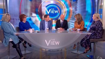 Nanushka Pene­lope Faux Leather Wrap Dress worn by Sunny Hostin on The View February 25, 2020