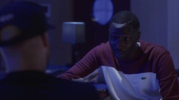 The sweatshirt is white and bordeaux Lacoste worn by William (Saidou Camara) in Validated (S01E09)