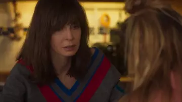 The gray sweater V-neck blue and red of Gabrielle (Anne Parillaud) in H24 (S01E05)