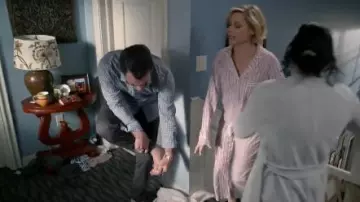 Pink Striped Pa­ja­mas worn by Claire Dunphy (Julie Bowen) in Modern Family Season 11 Episode 17