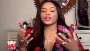 The kooples Black Silk Wrap Dress With Flo­ral Mo­tif worn by Eve on The Talk April 10, 2020