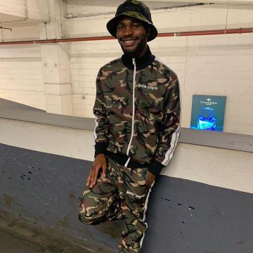 The tracksuit pants camouflage Palm Angels worn by David Omoregie on his account Instagram @santandave 