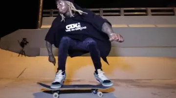 Comme des Garçons Ny­lon coat pon­cho Black worn by Lil Wayne in his Piano Trap & Not Me (Official Music Video)