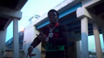 Sniper Gang Red & Green Striped Black Po­lo worn by Jack Boy in Spittin Facts (Official Music Video)