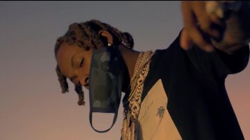 The oversize t-shirt printed book Dior and Daniel Arsham worn by Rich the Kid in the clip Racks On feat. YoungBoy Never Broke Again