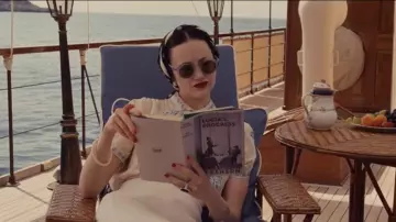 The book Lucia's Progress by E. F. Benson read by Wallis Simpson (Andrea Riseborough) in W.E.