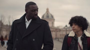 Abrigo largo de lana negra usado por Assane Diop (Omar Sy) como se ve en la serie de televisión Lupin (Temporada 1 Episodio 1)