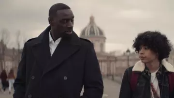 Black woolen long overcoat worn by Assane Diop (Omar Sy) as seen in Lupin TV series (Season 1 Episode 1)