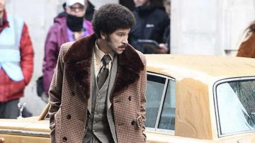 Trench coat with fur collar worn by Jasper (Joel Fry) as seen on the set in London of Cruella 2021