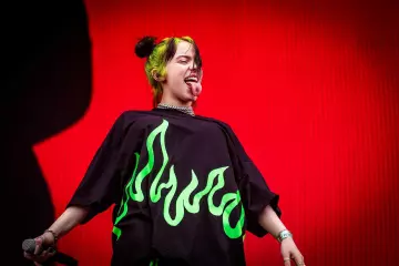 Neon Green flames black T-shirt worn by Billie Eilish at Pukkelpop Festival on August 18, 2019 