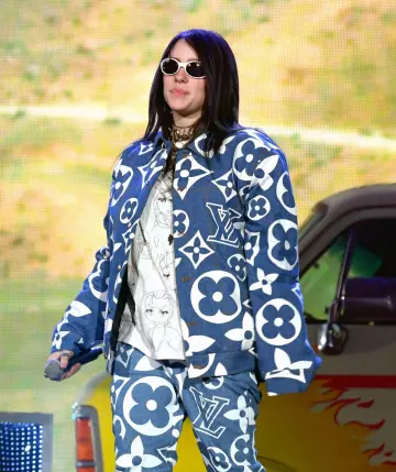Louis Vuitton Monogram Jacket and pants blue set worn by Billie Eilish for the 2019 Coachella Valley Music And Arts Festival on April 14, 2019 in Indio, California