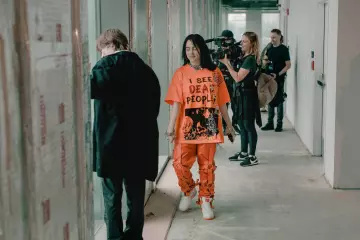 Problem6oy 'I See Dead People' Orange t-shirt worn by Billie Eilish on Billie Eilish: The World's a Little Blurry 
