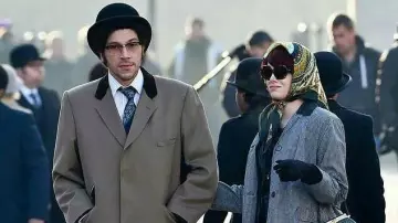 Grey long Coat worn by Jasper (Joel Fry) as seen on the set of Cruella movie