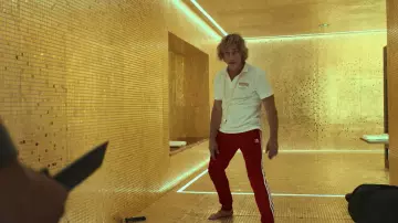 The tracksuit bottom red Adidas of Richard Brumére (Jean-Claude Van Damme) in the film The Last Mercenary