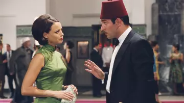 The long green satin dress and slit worn by Larmina El Akmar Betouche (Bérénice Bejo) in the film OSS 117: Cairo, Nest Of Spies