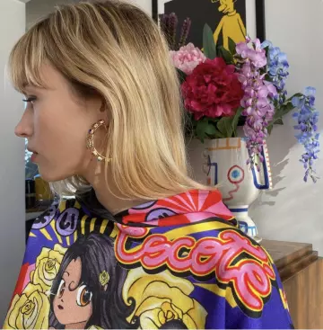 Anime printed hoodie sweatshirt worn by Angèle on a picture