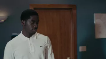 Lacoste White Polo Shirt worn by Franklin Saint (Damson Idris) as seen in Snowfall Outfits (Season 5 Episode 3)