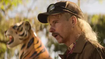 Oakley black sunglasses worn by Joe Exotic (John Cameron Mitchell) as seen in Joe vs Carole TV show wardrobe (Season 1 Episode 2)