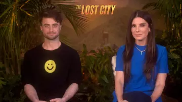 Yellow Happy Smiley Face  long sleeve sweatshirt in black worn by Daniel Radcliffe in Access Hollywood TV show on March 21, 2022