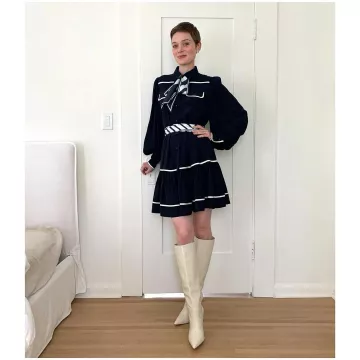 Zimmermann Black Striped Mini Dress with neck tie worn by Bella Heathcote on her Instagram account @bellaheathcote