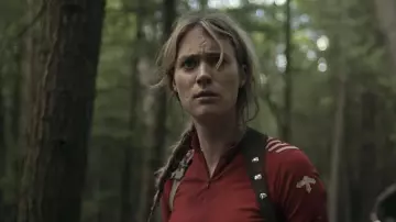 Descente 1/4 zip cycling top worn by Kirsten (Mackenzie Davis) as seen in Station Eleven TV series wardrobe (Season 1 Episode 1)