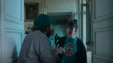 Sure Design Vintage Style Chang Beer T-shirt worn by Carla (Nora Hamzawi) as seen in Irma Vep (S01E05)