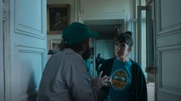 Russell Athletic Black Varsity Cardigan worn by Carla (Nora Hamzawi) as seen in Irma Vep (S01E05)