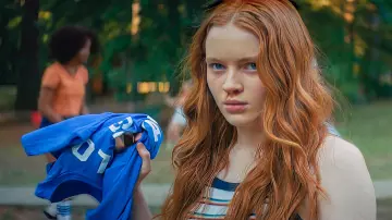 Color War 78 Tee in blue held by Ziggy Berman (Sadie Sink) in Fear Street: 1978