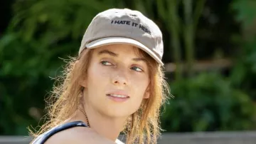 "I hate it here" beige hat cap worn by Eleanor (Maya Hawke) in Do Revenge movie outfits