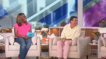 DKNY Mixed Media Ruffle Sleeve Crewneck Top worn by Sheryl Underwood as seen in The Talk on October 6, 2022