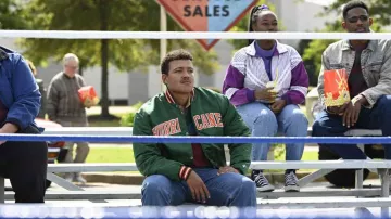 Starter Miami Hurricanes Satin Jacket in green worn by Dwayne Johnson (Bradley Constant) as seen in Young Rock (Season 3 Episode 1)
