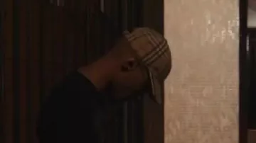 Freeze Corleone wears a Burberry plaid cap in his music video Hors Ligne