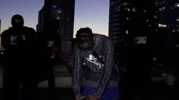 The crewneck sweatshirt Please Paulo Stop Cappin worn by OBOY in his music video FAST FAST
