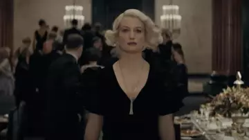 The mid-length black dress worn by Queenie Goldstein (Alison Sudol) in the movie Fantastic Beasts - Dumbledore's Secrets