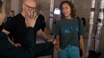 Kid Cudi Cu­di Saves graph­ic tee worn by Cate Hall as seen in Glow Up: Britain's Next Make-Up Star (S02E02)